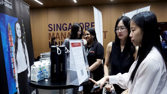 Attentive students reading something at the career fair