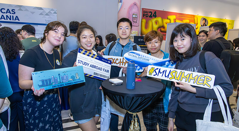 International students holding up various signages